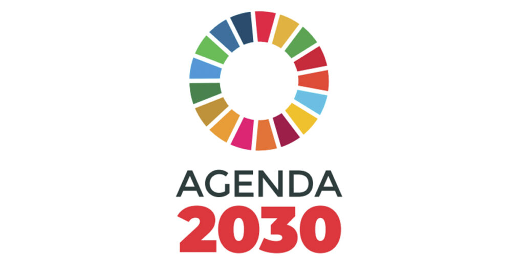 Logo, jossa teksti "Agenda 2030" ja eri värisistä palikoista muodostuva ympyrä.
